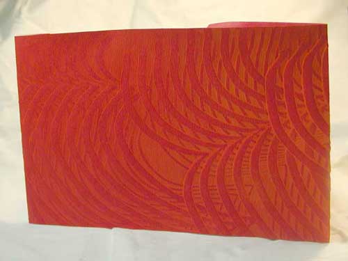 Paste paper cover of a two-holed album covered blank book.