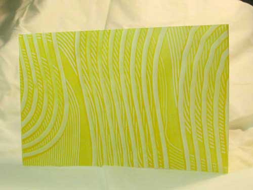 The paste paper cover of a three-holed album covered blank book.