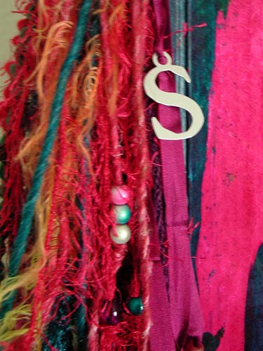 This book was embellished with a variety of yarns, ribbons, beads and a specil charm.