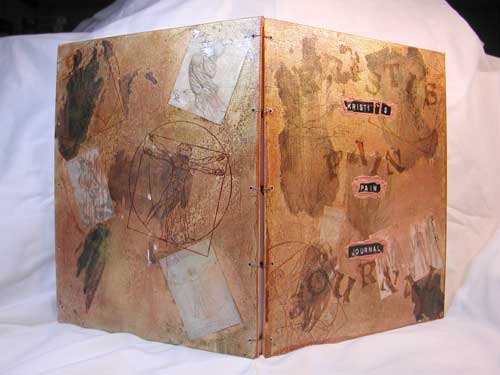 A view of the covers of Krist's coptic stitched pain journal.