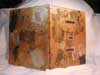 A coptic stitch pain journal made wth canvas board covers.