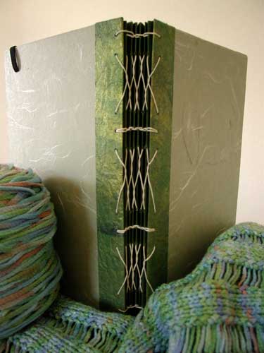A view of the functional, yet decorative stitching for the spine of this extrordinary fiber arts journal.