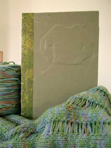 Sage green hand bound knitting journal by Kristi Schueler.