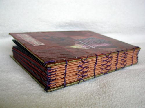 A view of the binding using herringbone, chain and headband stitching on Kristi's Eggplant and Pumpking New Colors journal.