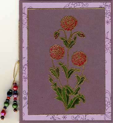 This pamphlet stitch booklet features images from Ink-n-Rubber Expressions and is colored iwth colored pencil, bound with gold embroidery floss and adorned with beads.