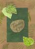 A kraft card stamped and collaged with leaves.