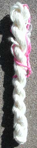 An overexposed image of a wonderful shiny bleached tussah silk 2-ply handspun yarn.