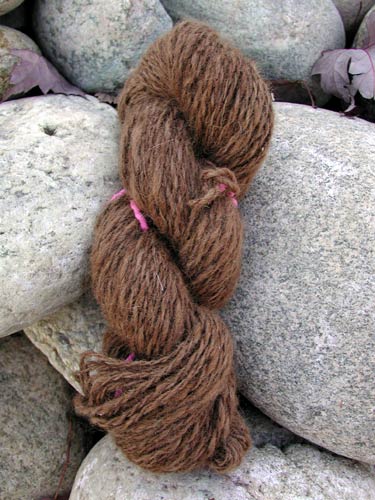 Light red alpaca 2-ply worsted weight yarn.