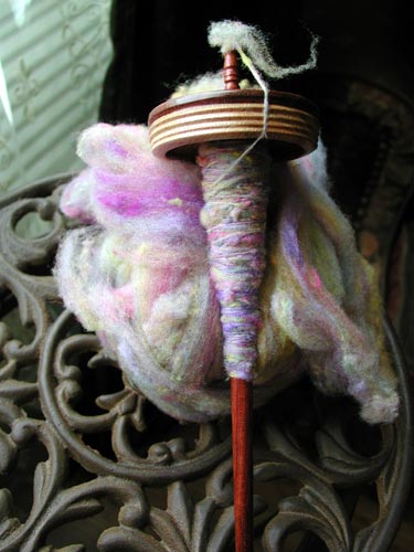 Kristi very first spindle spun yarn, spun of rainbow colors Targhee.
