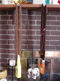Both alpaca hand spun yarns blocking on the mantle.