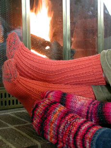 Both pairs of dimple socks being warmed by the fire.