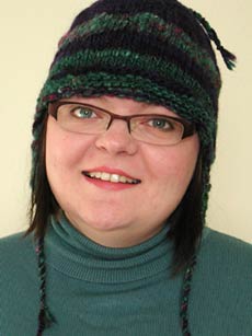 Straight on shot of the earflap hat being modeled.