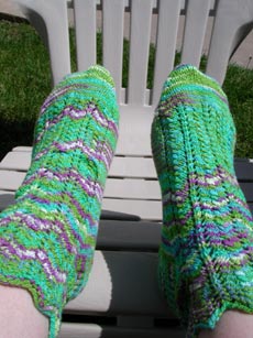 Heatwave socks resting on resin adirondack chair.
