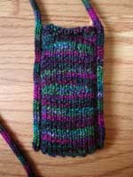 A necklace case for an iPod Nano made from left over sock yarn.