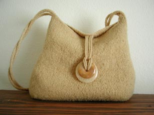 A felted Sohpie bag with gemstone donut closures.
