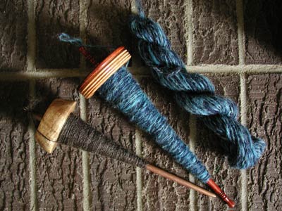 Two drop spindles, the brown of singles and the blue of 2-ply Coopworth.