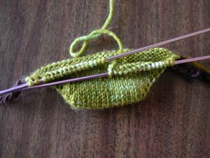 The beginnings of swamp sock using a provisional cast-on and a short row toe.